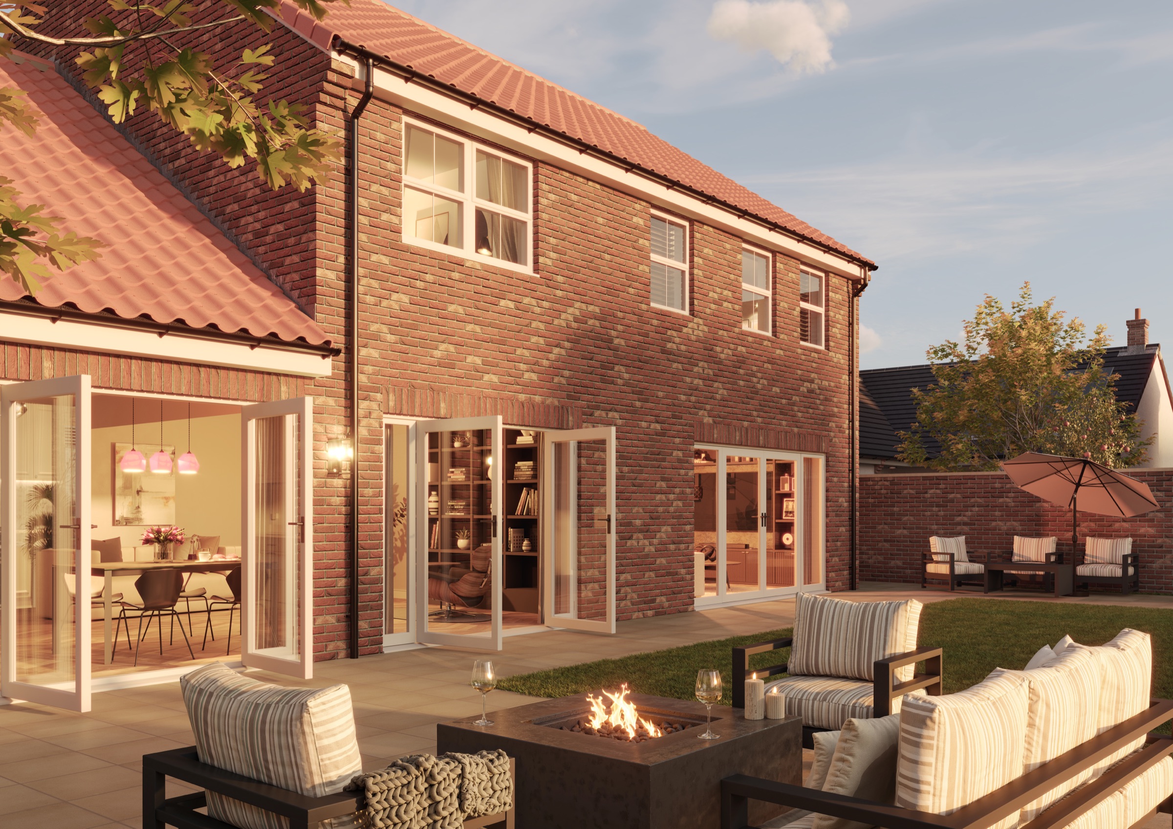 The patio behind a red-brick Oakmere home, with a fire pit, outdoor sofas and folding doors to the kitchen